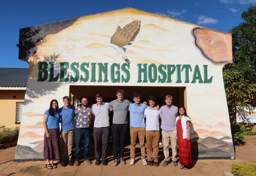 Team standing in front of the Blessings Hospital in Malawi