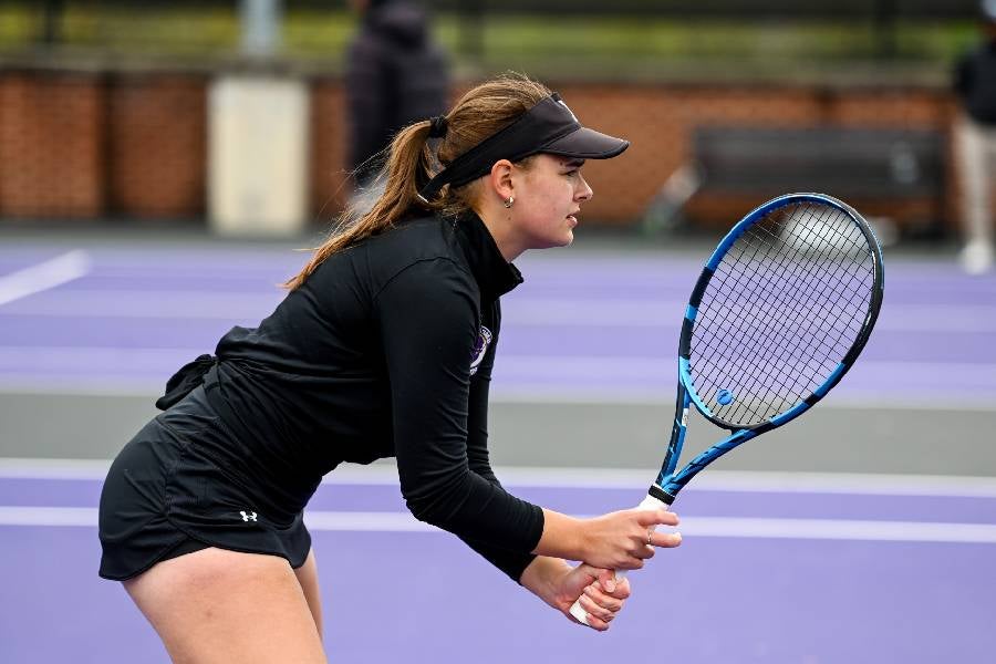 Sofiia Paladi swinging a tennis racket. 