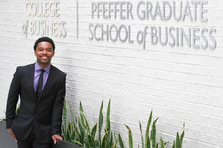 Nate Wallace standing inside the College of Business in the Swang Center. 