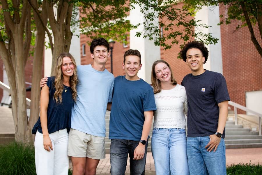 Five Lipscomb students standing together outside on campus