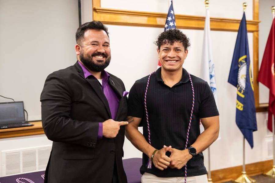 Otilio Torres Davila receiving his academic cords from Veteran Services. 