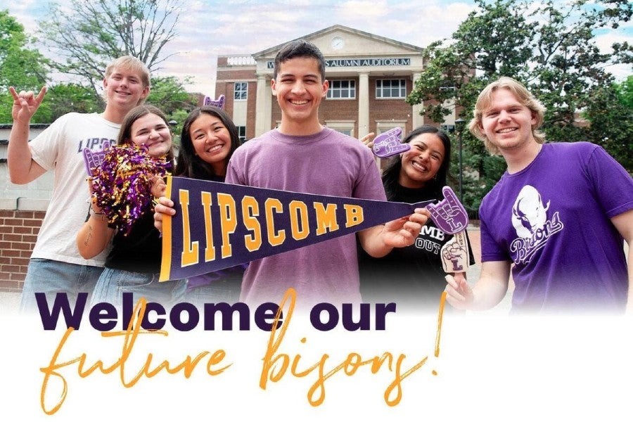 students on campus smiling and posing with a Lipscomb banner