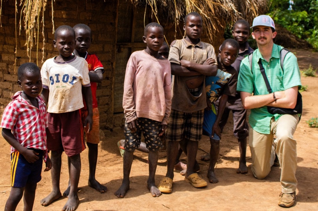 Student gathered with children from the village in Uganda. 