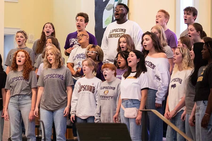 Group of college students wearing Lipscomb shirts singing 