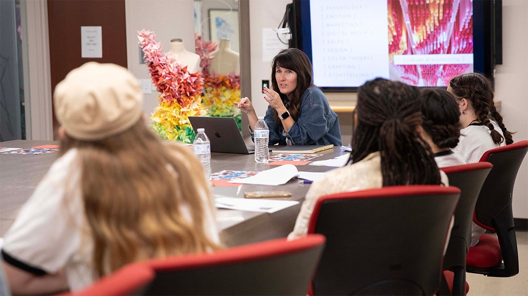 Students in the Fashion Lab learning from department chair Charlotte Poling