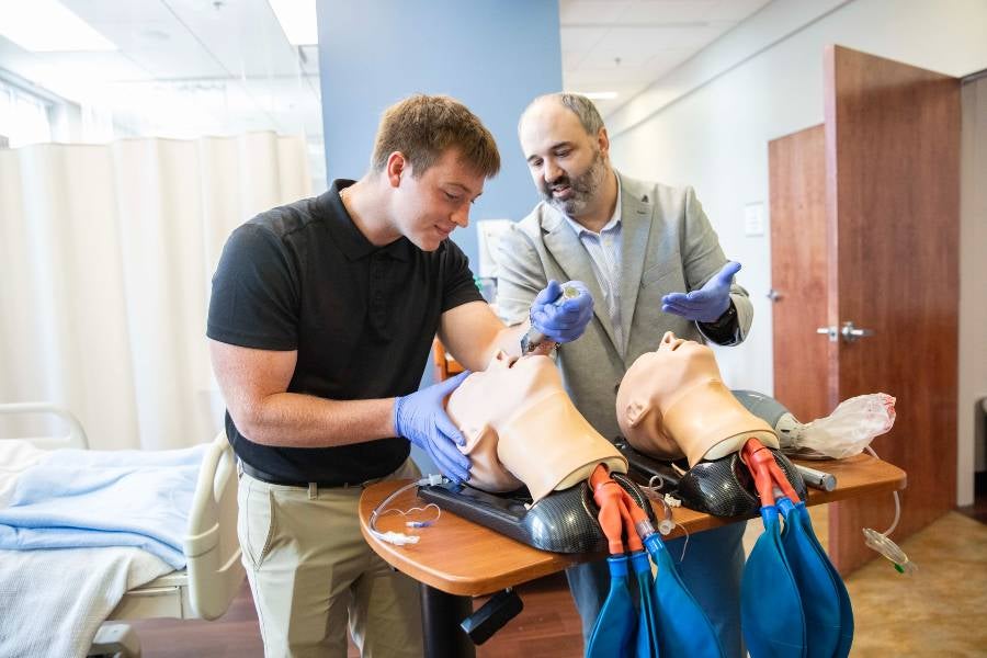 Lipscomb professor Todd Christian works with a student in a lab on Lipscomb's campus. 