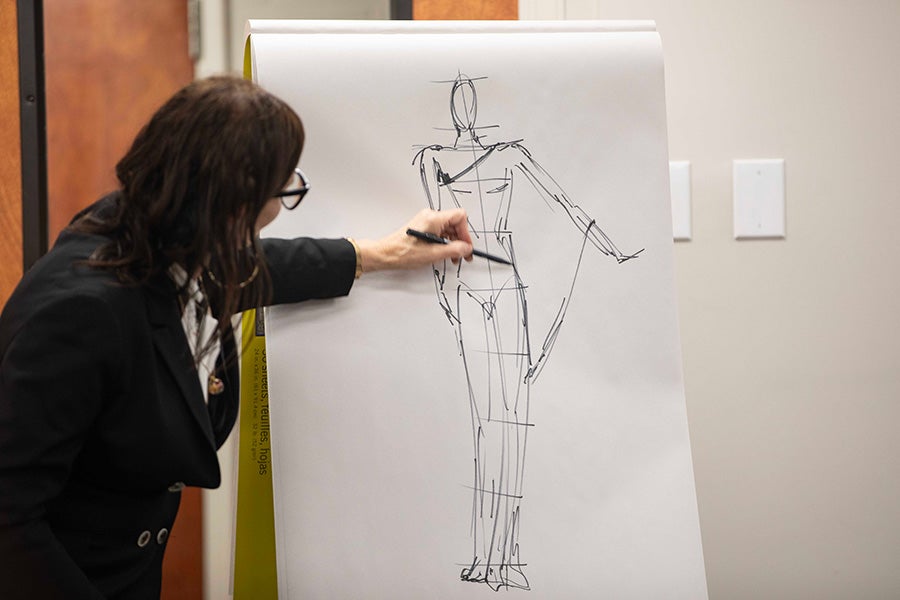 Fashion illustrator Carrie Mills working on an illustration