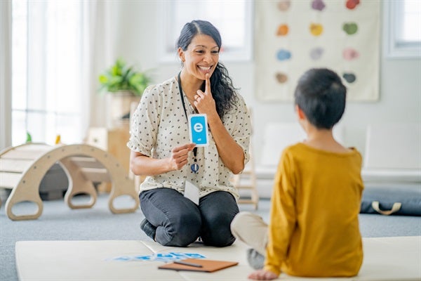 Speech therapist works with child to improve communication skills