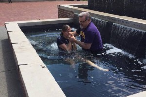 Dr. Gallaher baptizing student in Lipscomb fountain