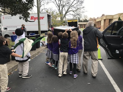 Third graders lifting refrigerator. 