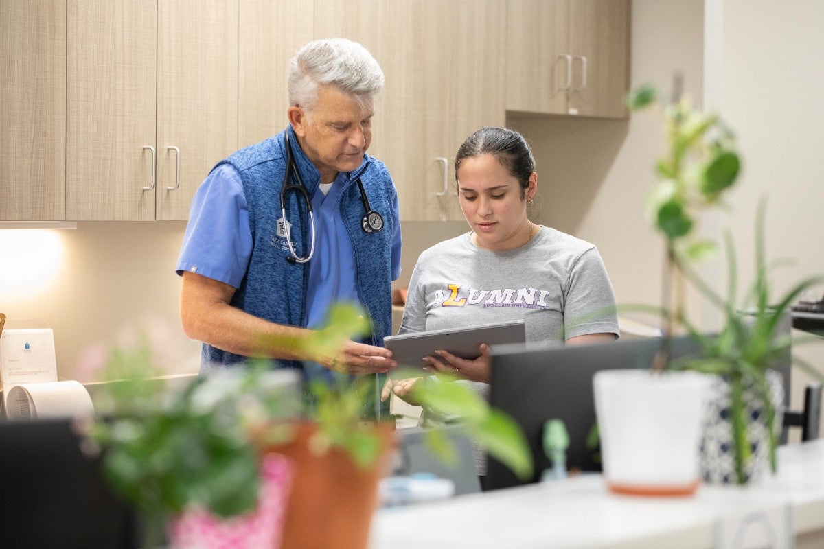 Dr. Parker Panovec and Valeria Ochoa working together at the clinic