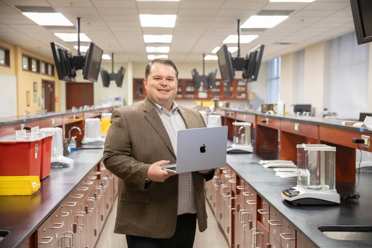 Jay Dorris with his computer in a pharmacy lab