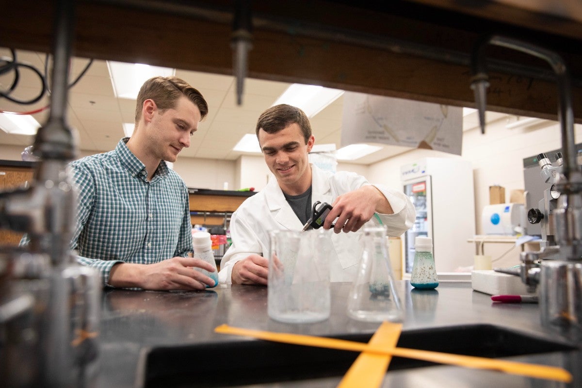 Josh Owens working with a student in the lab