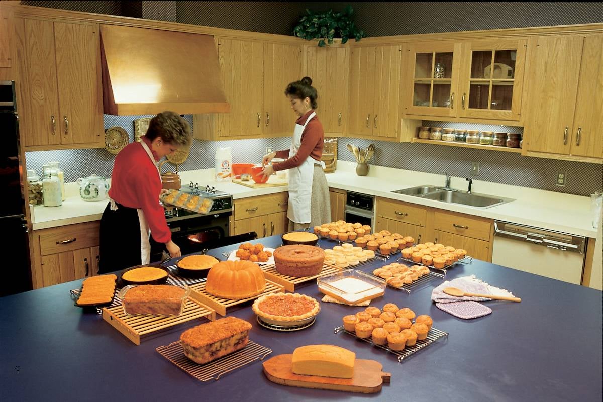 Linda Carman at right working in the Martha White test kitchen