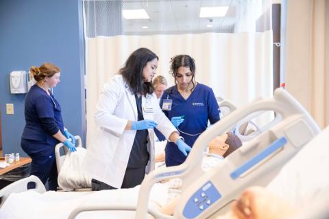 Nursing students and professors in the health simulation lab