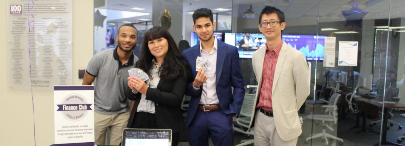 students at their booth for a business fair