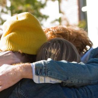 students huddled together in prayer