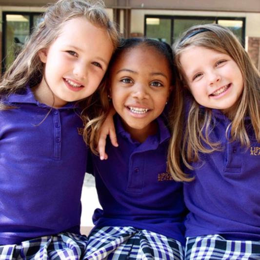 three young girls in uniforms