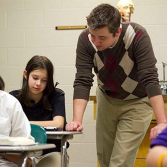 Teacher helping a student in a classroom