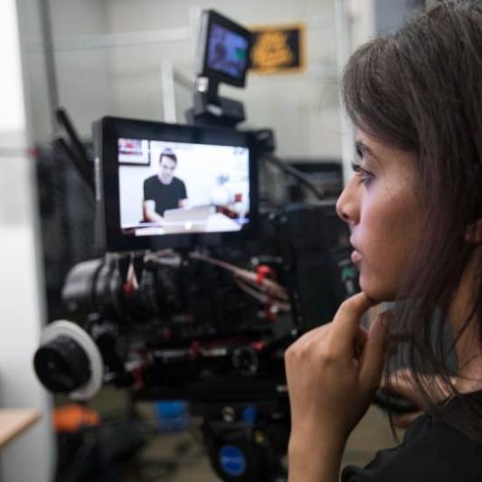 student watching the camera monitor during filiming