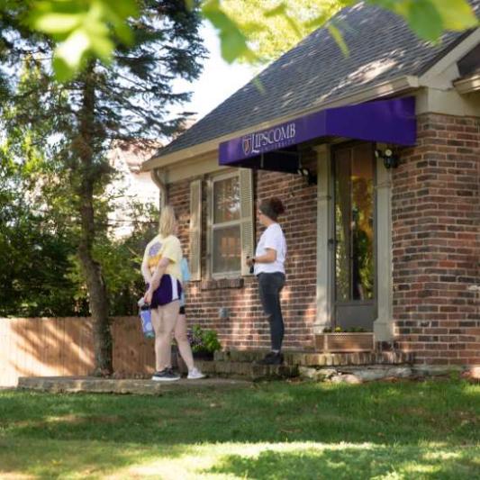 students talking outside the honors house