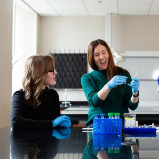 Student with professor in lab