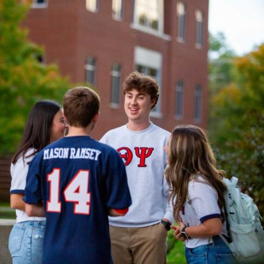 students in a group together on campus