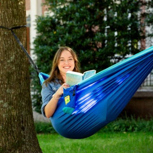 Student in hammock on campus