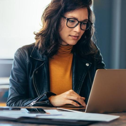 Business woman working on a laptop in a professional office