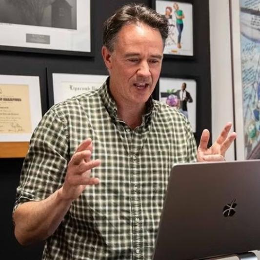 Animation professor speaking to his class online.
