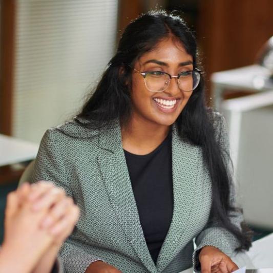 Young professional smiling with her colleagues