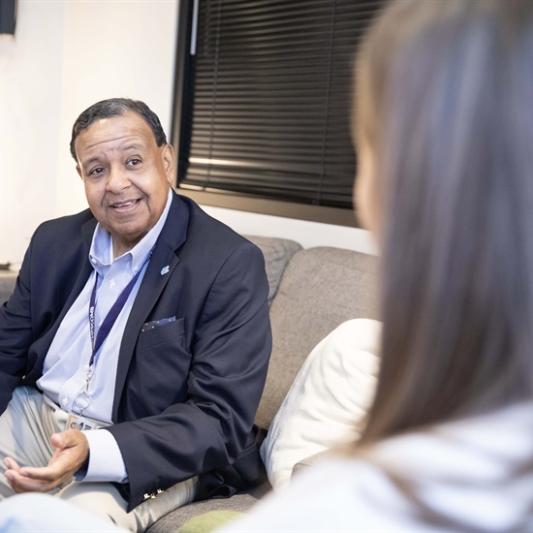 Therapist talks to client on couch
