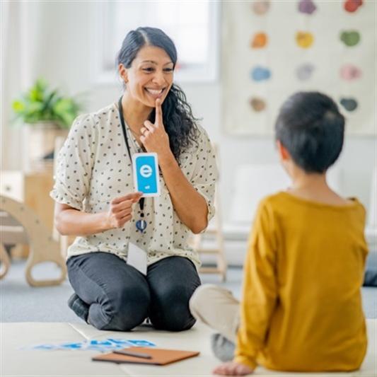 speech-language pathology professional working with a child