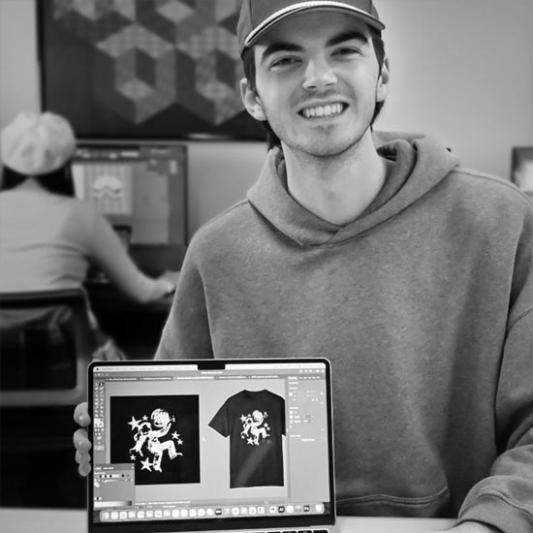 Student showing their work in Graphic Design class