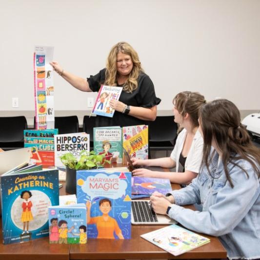 Professor leading a student group researching children's literature
