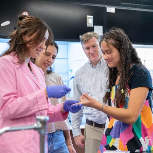 Students with their professor collecting blood drops
