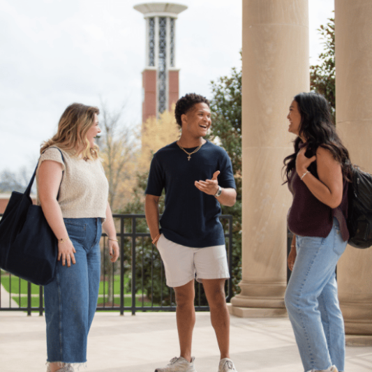 Students talking in front of the belltower