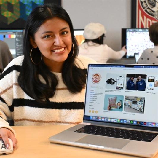 a student showing off their graphic design work
