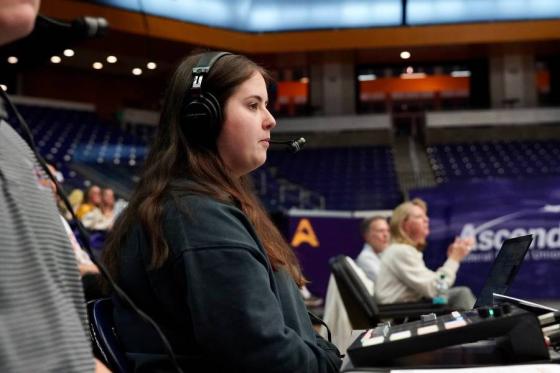 Alaina Morris broadcasting a basketball game. 