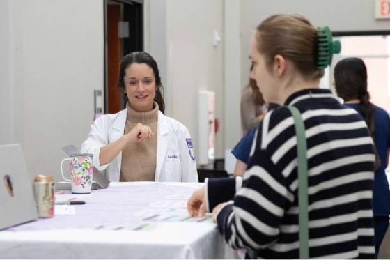 Professor from the School of Physician Assistant Studies meets with students. 
