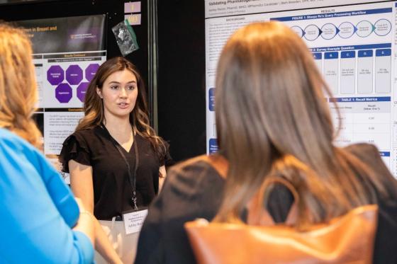 Graduate Ashley presenting a poster at Lipscomb's student research symposium