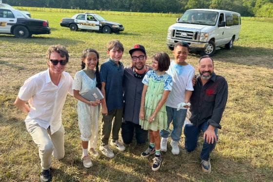 Lead producer Steve Taylor, left, director Seth Worley, center, and lead actor Tony Hale, right, with child actors on the set of SKETCH.