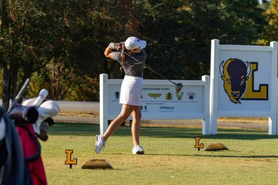 Women's golf player on the driving range.