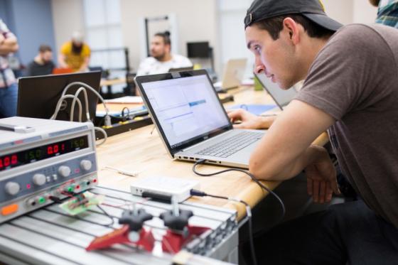 Engineering student working with equipment and computer