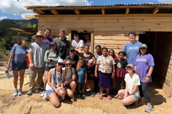 Honduras mission team standing near a home it built. 