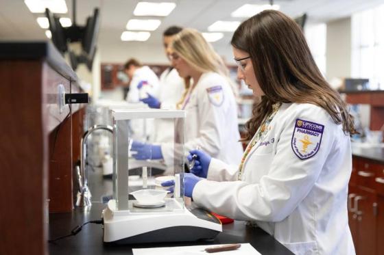 Three students in the College of Pharmacy lab. 