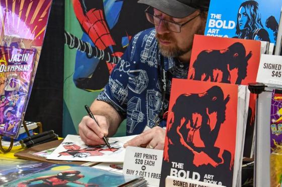 Vendor at his Animation Y'all! booth drawing