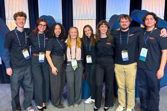 Group photo of business students standing together at the AMA competition. 