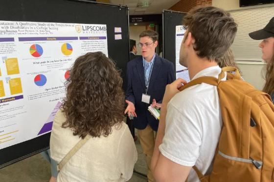 Carson Borgman explains his research to several students at the Student Scholars Symposium. 