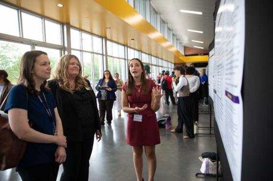 Students presenting posters in Allen Arena during the symposium